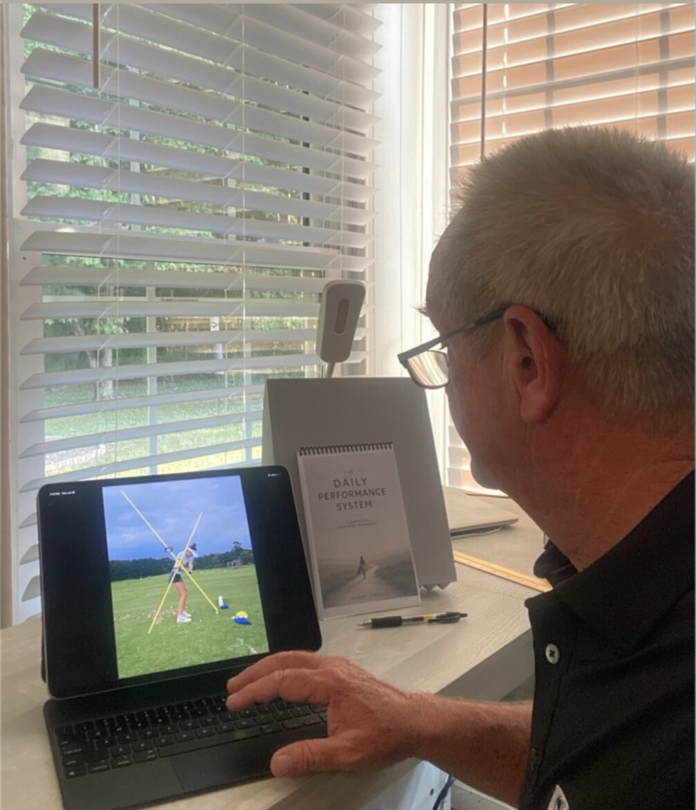 Robert Linville reviewing a player's golf swing remotely